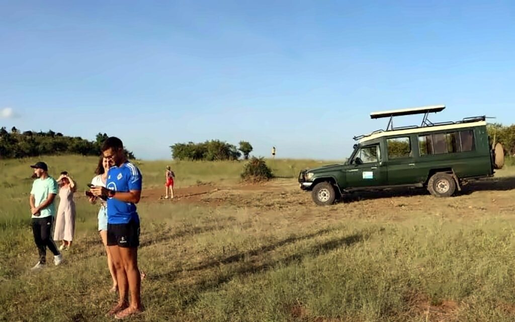 Safari vehicle on a game drive in the Maasai Mara, Kenya